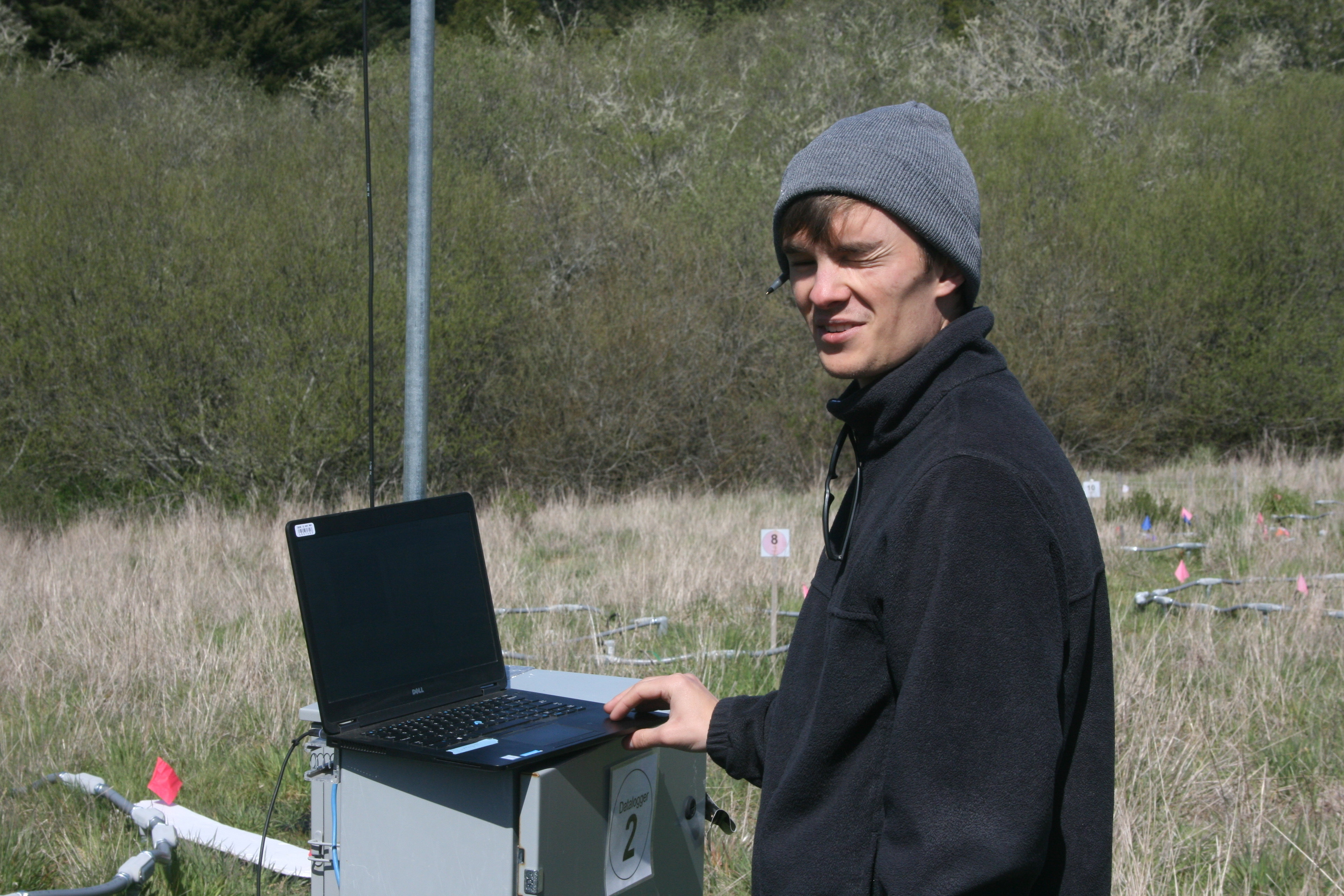 Picture of myself squinting doing SIF imagery fieldwork.